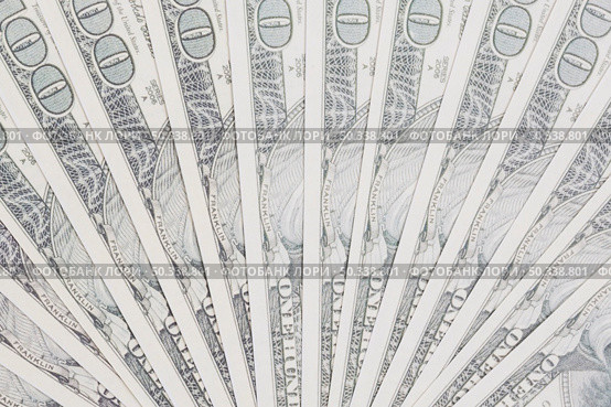 one hundred dollars bills spread out fan shape. Стоковое фото, агентство Ingram Publishing / Фотобанк Лори