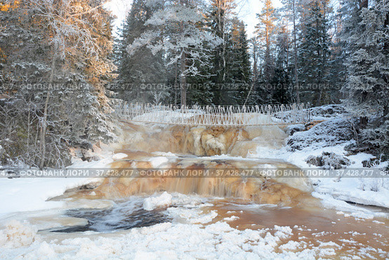 One of the most famous places in the Republic of Karelia is the Ruskeala waterfalls (the filming location of the Soviet film "The Dawns Here Are Quiet...") in the winter season. Traveling in Russia, Republic of Karelia. Стоковое фото, фотограф Алексей Кокоулин / Фотобанк Лори