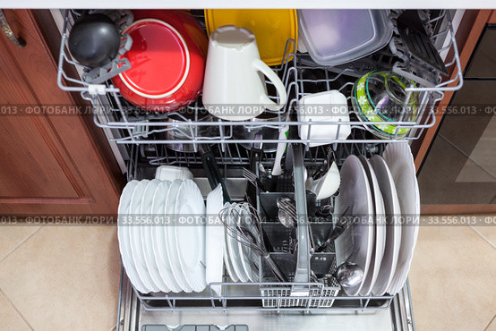 Opened dishwasher machine with clean utensil, steel spoons and cups is in the kitchen, top view. Стоковое фото, фотограф Кекяляйнен Андрей / Фотобанк Лори