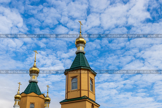 Orthodox Church building with golden domes and crosses against the background of the sky and clouds. Church of St. Sergius of Radonezh, city of Magadan, Magadan Region, Russian Far East, Siberia. Стоковое фото, фотограф Андрей Степанов / Фотобанк Лори