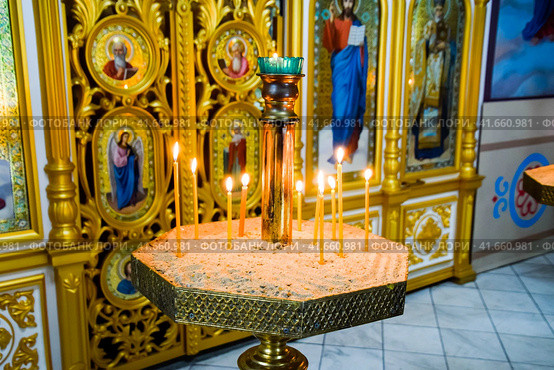 Orthodox church from the inside. Burning wax candles in front of icons and frescoes. Christian religion. Стоковое фото, фотограф Леонид Еремейчук / Фотобанк Лори