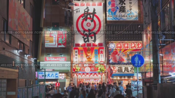 Osaka, Japan - Sep 22 2024, 4k, Panoramic view of Dotonbori street with various cafes, restaurants, bright signs and advertisements, illumination, a lot of people walking, at night, Osaka, Japan. Редакционное видео, видеограф Сергей Богомяко / Фотобанк Лори