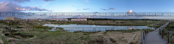 OVAR, PORTUGAL - 20 DECEMBER 2022: Heavy rainfall causes the water table to rise to the seafront of Furadouro in Ovar. The advance of the sea due to climate change threatens Portugal. Стоковое фото, агентство Ingram Publishing / Фотобанк Лори