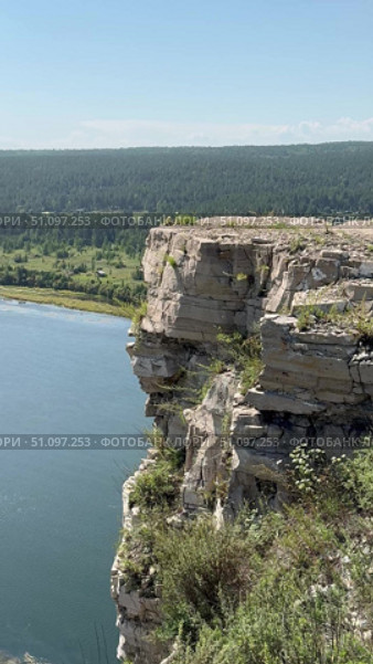 Overview vertical video of natural landmark - steep White Rocks along bank of Siberian Belaya River, near village of Kholmushino, Usolye-Sibirskoye district, Irkutsk region. Beautiful summer landscape. Стоковое видео, видеограф Виктория Катьянова / Фотобанк Лори