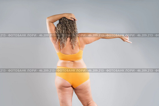 Overweight thigh, woman with fat hips, back and buttocks, obesity female body with cellulite on gray background. Стоковое фото, фотограф Станислав Тарко / Фотобанк Лори