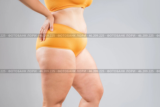 Overweight thighs, woman with fat hips and legs, obesity female body with cellulite on gray background. Стоковое фото, фотограф Станислав Тарко / Фотобанк Лори