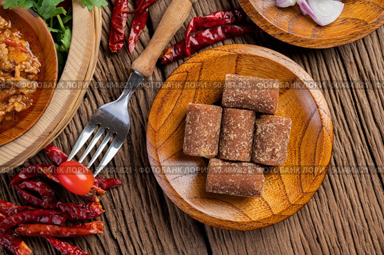 Palm sugar, red onions, dried peppers, tomatoes, cucumbers, yard long beans and lettuce in a bowl. Стоковое фото, агентство Ingram Publishing / Фотобанк Лори