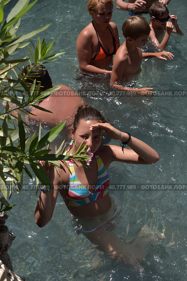 Pammukale, Turkey - July, 19, 2015: People in antique Cleopatra's pool with thermal water in ancient city Hierapolis, near modern Turkey city Denizli. Редакционное фото, фотограф Анна Кривицкая / Фотобанк Лори