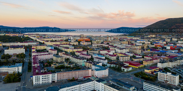 Panorama of the city of Magadan. Beautiful morning cityscape. Aerial view of buildings and streets. In the distance there are mountains and a sea bay. Magadan, Magadan Region, Far East Russia. Siberia. Стоковое фото, фотограф Андрей Степанов / Фотобанк Лори