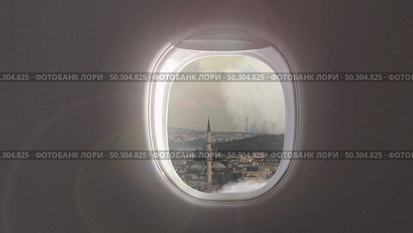 Panoramic aerial video of cityscape with buildings and houses of historical part of Istanbul, Turkey on a background of cloudy sky from porthole inside airplane.. 4K UHD video 3840, 2160p.. Video of cityscape of historical part of Istanbul, Turkey from porthole inside airplane. Стоковое фото, агентство Ingram Publishing / Фотобанк Лори