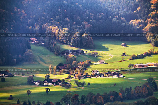 Panoramic view of beautiful mountain rural landscape in the Alps with village in the backgroundFantastic views of Austrian green hills. Beauty world. Colorful mountain landscape of austrian alps in Mondsee. . Стоковое фото, агентство Ingram Publishing / Фотобанк Лори