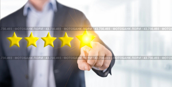 Person man pointing on 5 star review, costumer feedback concept - five stars rating. Feedback, reputation and quality concept. blurred office background. Стоковое фото, фотограф Павел Муравьев / Фотобанк Лори