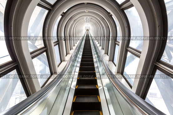 perspective escalators stairway inside contemporary blue glass business centre, concept of successful career elevation. Стоковое фото, агентство Ingram Publishing / Фотобанк Лори