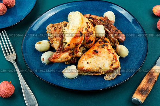 Pieces of roasted chicken with lychee on a plate. Grilled poultry.. Baked chicken with lychee. Стоковое фото, агентство Ingram Publishing / Фотобанк Лори