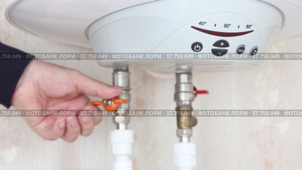 Plumber is connecting boiler to domestic water supply system. Стоковое видео, видеограф Владимир Григорьев / Фотобанк Лори