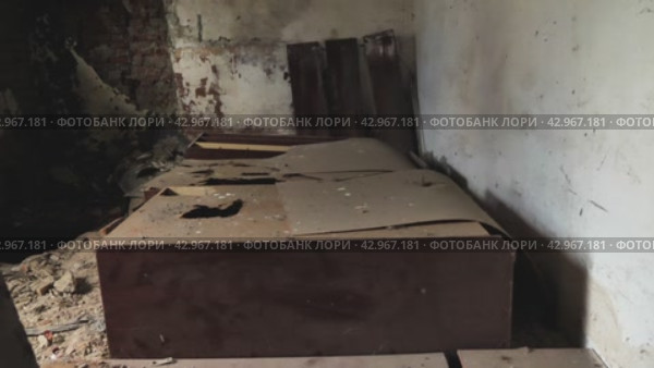 Помещения заброшенной фабрики. На стенах видны следы плесени и гнили. На полу валяются шкафы. Полуразрушенное здание служит напоминанием о промышленной истории, оставленной на произвол судьбы. Стоковое видео, видеограф Воловодов Владимир / Фотобанк Лори