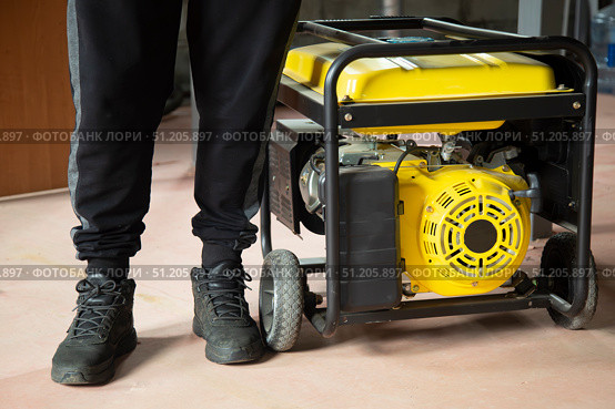 Portable gasoline generator.The use of an autonomous energy source. An additional source of energy. Стоковое фото, фотограф Александр Поташев / Фотобанк Лори
