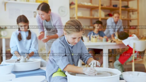 Portrait of a ceramics teacher with students and finished works after a master class. Teenage boy show clay products made themselves in the art studio. Стоковое видео, видеограф Яков Филимонов / Фотобанк Лори