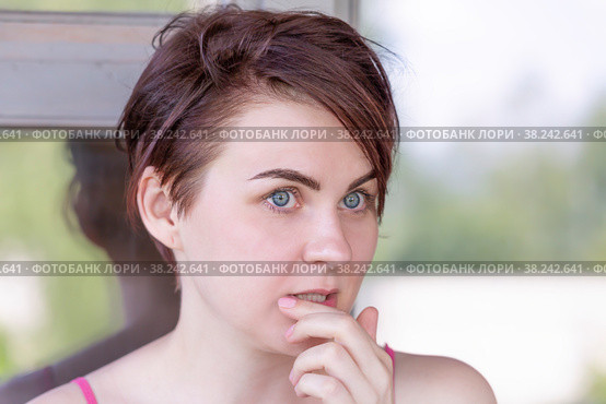 Portrait of a girl, thoughtfully touching her hand to her lips. Стоковое фото, фотограф Татьяна Дворецкая / Фотобанк Лори