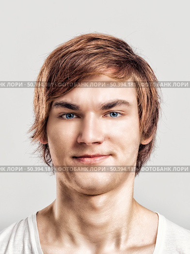 Portrait of a handsome young man, over a gray background. Стоковое фото, агентство Ingram Publishing / Фотобанк Лори
