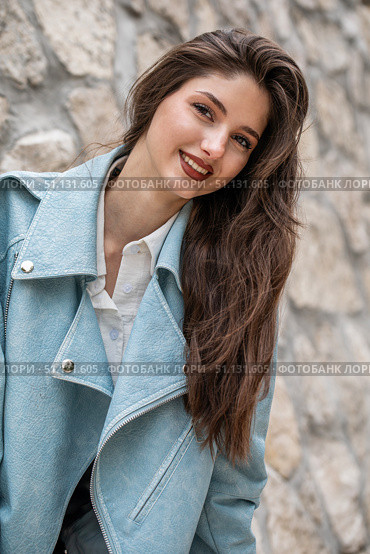 Portrait of a young beautiful brunette woman in a blue leather jacket. Стоковое фото, фотограф Андрей Аркуша / Фотобанк Лори