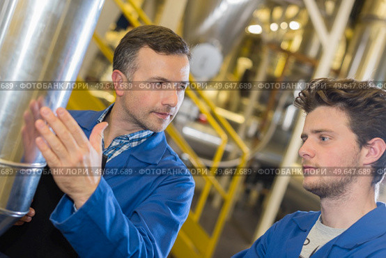 portrait of an apprentice in factory. Стоковое фото, агентство Ingram Publishing / Фотобанк Лори