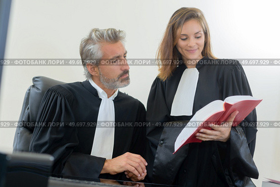 portrait of judges reading law book. Стоковое фото, агентство Ingram Publishing / Фотобанк Лори