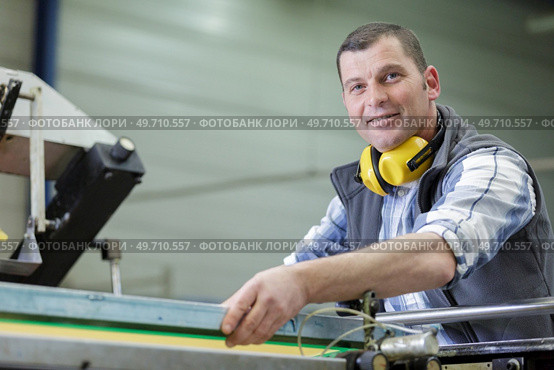 portrait of male engineer with cad drawings in factory. Стоковое фото, агентство Ingram Publishing / Фотобанк Лори