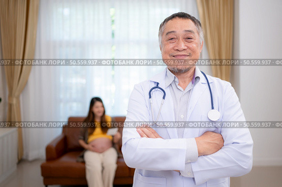 Portrait of obstetrician gynecologist, Asian pregnant woman visit gynecologist doctor at medical clinic for pregnancy consultant. Стоковое фото, агентство Ingram Publishing / Фотобанк Лори