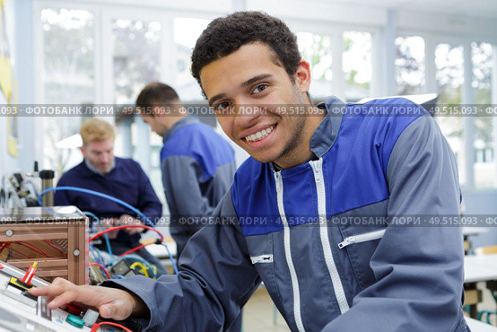 portrait of young technician at controls of machine. Стоковое фото, агентство Ingram Publishing / Фотобанк Лори