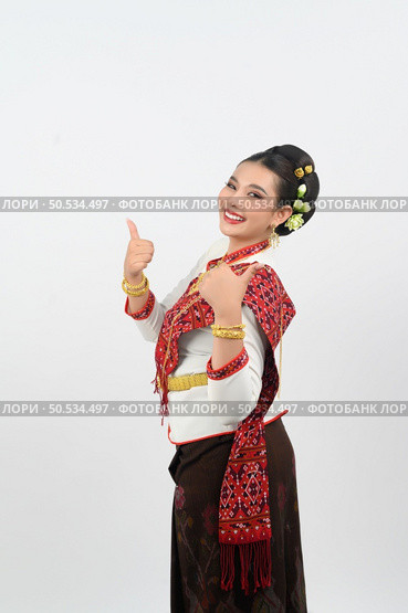 Portrait young pretty woman dress up in beautiful  local culture in northern region with gladtful posture, grimace and thumb up and smile on white background, copy space. Стоковое фото, агентство Ingram Publishing / Фотобанк Лори