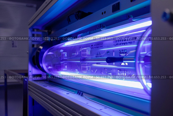 Powerful uv light inside medical equipment sterilizing machine. Стоковое AI-изображение, AI-художник Иван Рябоконь / Фотобанк Лори