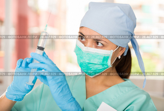 Professional nurse young woman making injection in hospital. Стоковое фото, фотограф Яков Филимонов / Фотобанк Лори