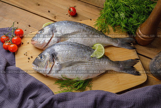Raw peeled dorado fish with cooking ingredients. Fresh fish on a wooden background. Стоковое фото, фотограф Юрий Поздников / Фотобанк Лори