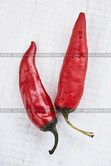 Red hot chili peppers on a white background. Стоковое фото, фотограф Елена Вишневская / Фотобанк Лори