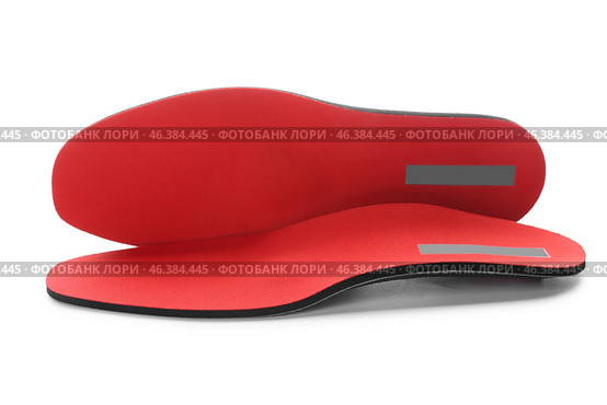 Red orthopedic insoles isolated on white background. Стоковое фото, фотограф Pixel_shot / Фотобанк Лори