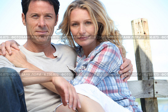 Relaxed mature couple sitting in the sunshine. Стоковое фото, фотограф Phovoir Images / Фотобанк Лори