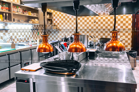 Restaurant kitchen without people. There is no one in kitchen of cafe. Concept - work in restaurant has been stopped. Small restaurant kitchen with chrome equipment. Dishes and products on tables. Стоковое фото, фотограф Евгений Ткачёв / Фотобанк Лори
