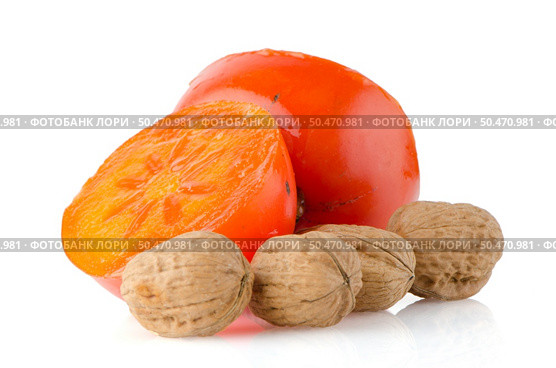 Ripe persimmons and nuts on white background. Стоковое фото, агентство Ingram Publishing / Фотобанк Лори