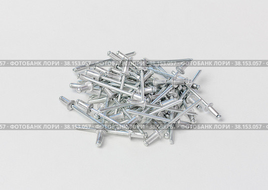 Rivets for the riveter or manual and electric rivet gun on a gray background. Стоковое фото, фотограф Андрей С / Фотобанк Лори