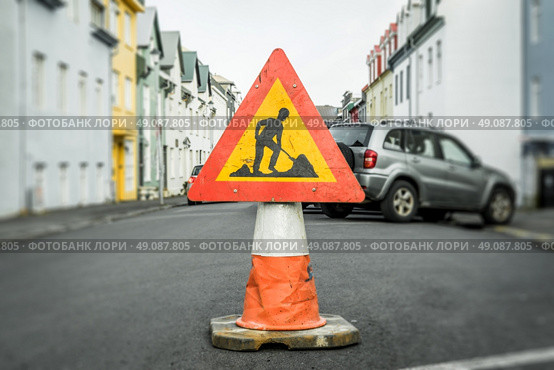 Roadwork sign on a cone at a street. Стоковое фото, агентство Ingram Publishing / Фотобанк Лори