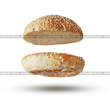 Roasted toasted burger top without fillings flying, levitating at white.. Burger bun empty isolated. Стоковое фото, агентство Ingram Publishing / Фотобанк Лори