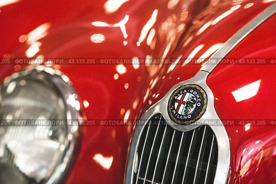 RUSSIA, MOSCOW - May 11, 2024: Close-up of the Alfa Romeo logo on the hood of a retro car. Редакционное фото, фотограф Photojuli / Фотобанк Лори