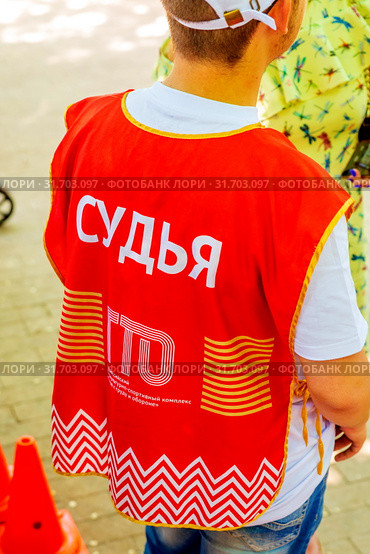 Russia Samara June 2019: a young man, a judge of the GTO, on a summer sunny day in a park on the urban gymnastics. Text in Russian: the judge of the GTO. Редакционное фото, фотограф Акиньшин Владимир / Фотобанк Лори