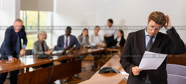 Sad middle aged white brunette businessman being reprimanded and fired. Стоковое фото, фотограф Яков Филимонов / Фотобанк Лори