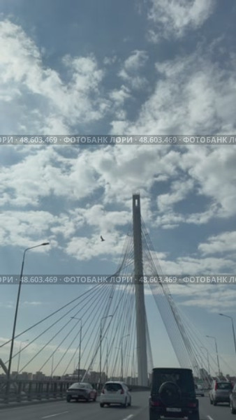 SAINT PETERSBURG, RUSSIA - May 13, 2025: Vertical video of traffic on Western High-Speed ​​Diameter WHSD and beautiful cable-stayed bridge against the backdrop of blue sky across the Petrovsky fairway. Редакционное видео, видеограф Виктория Катьянова / Фотобанк Лори