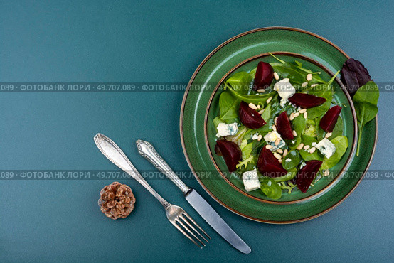 Salad with boiled beets, blue cheese, herbs and pine nuts. Food recipe background. Copy space. Vegetable salad with beets, cheese and herbs. Стоковое фото, агентство Ingram Publishing / Фотобанк Лори