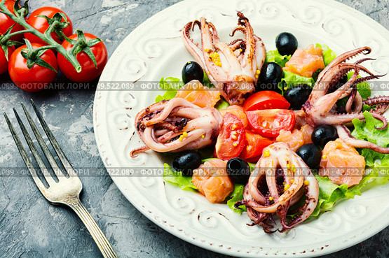 Salad with calamari, salmon and vegetables.Seafood concept. Salad with squid and seafood. Стоковое фото, агентство Ingram Publishing / Фотобанк Лори