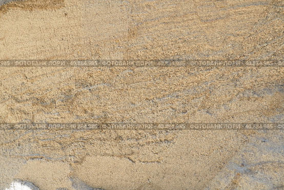 Sandstone is a fragmentary sedimentary rock, a homogeneous or layered aggregate of fragmentary grains and grains of sand bound by any mineral substance, cement. Quarry natural yellow sand wall. Стоковое фото, фотограф Юлия Петровская / Фотобанк Лори