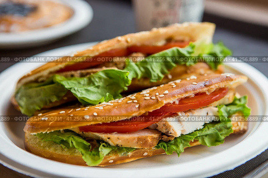 Sandwich of wheat bread with tomatoes, cheese salad, herbs and chicken. Стоковое фото, фотограф Photojuli / Фотобанк Лори